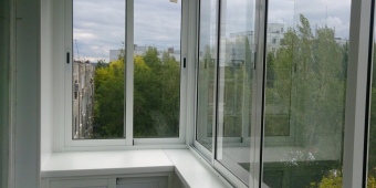 Холодное Г - образное остекление балкона с отделкой панелями из пластика